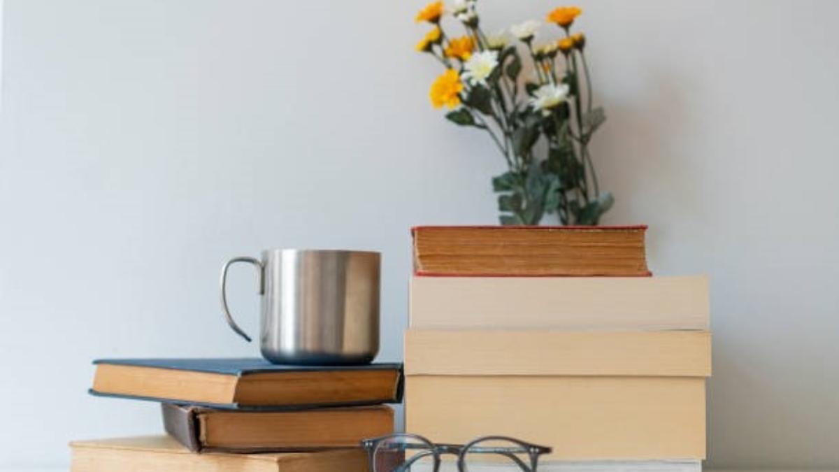 Stack of books, glasses, and coffee in home interior